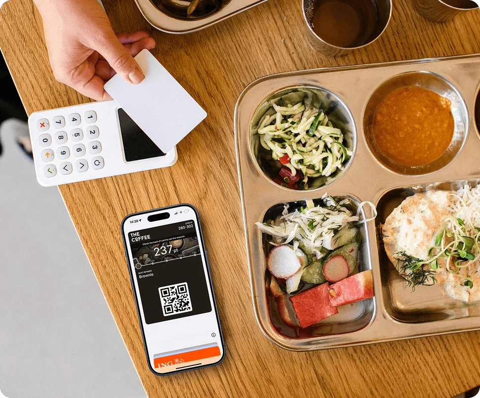 A person using Tap2's loyalty app on their phone next to their premium dinner at a Tap2 partner restaurant.